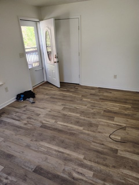 the living room is ready to be remodeled with wood flooring