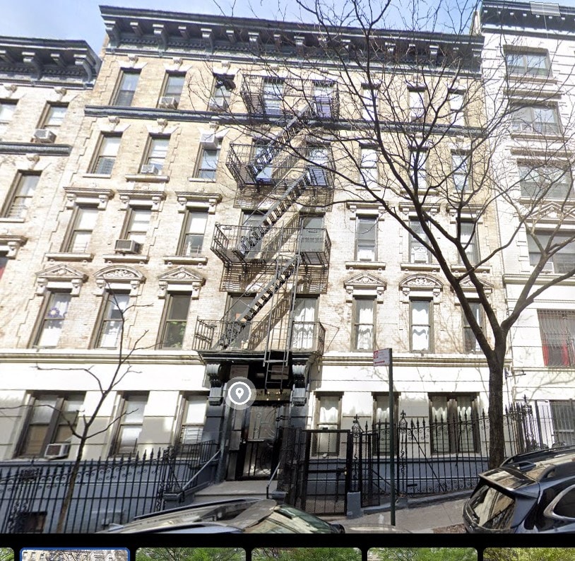 the apartment building has a fire escape on the side of it