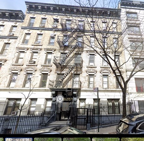 the apartment building has a fire escape on the side of it