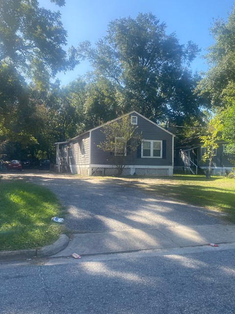A house is situated on a street with a green lawn.