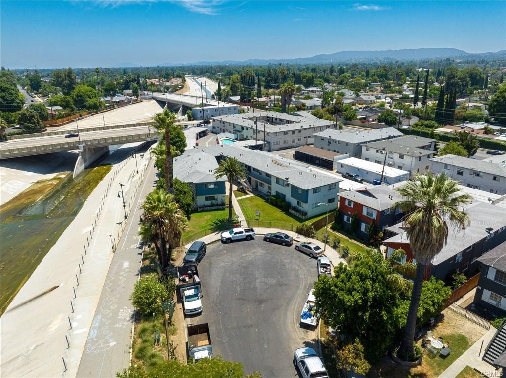 A residential area with houses and parked cars.