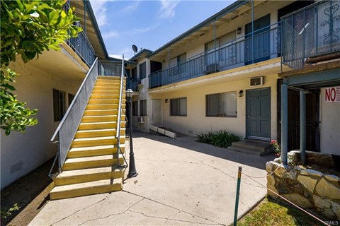 A building with a yellow staircase in front of it.