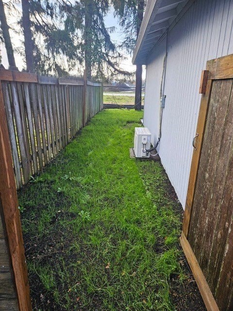 A wooden fence runs along the side of a house.