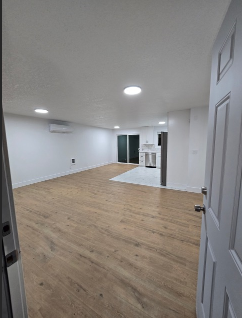 A room with a wooden floor and white walls.
