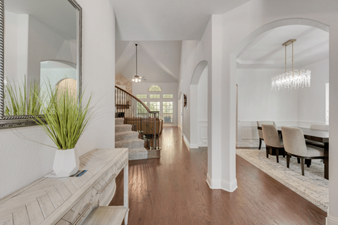a view of the living room and dining room from the foyer of a house