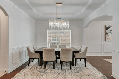 a dining room with a table and chairs and a large chandelier