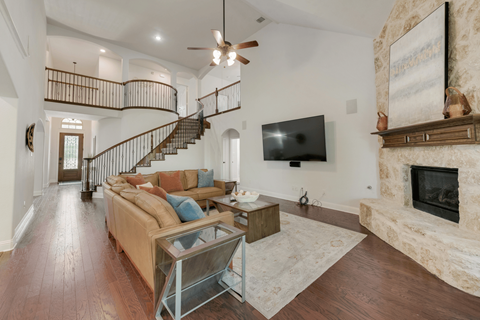 a living room with a fireplace and a tv