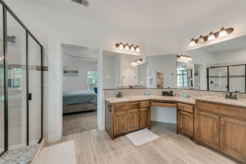 a bathroom with a sink and a shower and a mirror