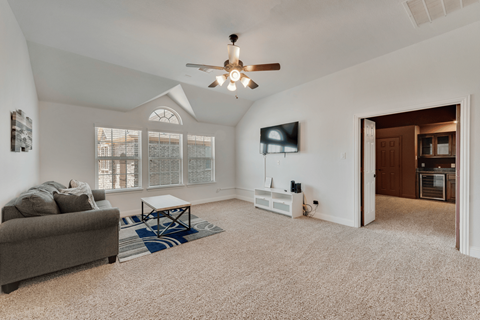 a living room with a ceiling fan and a couch
