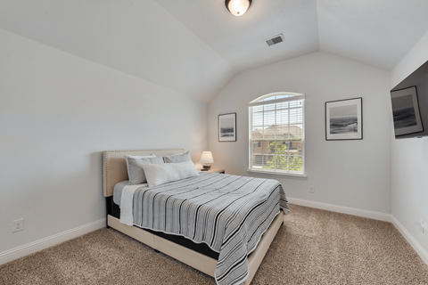 an attic bedroom with a bed and a window