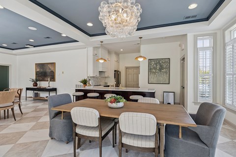 a kitchen with black cabinets and granite counter tops and a black refrigerator