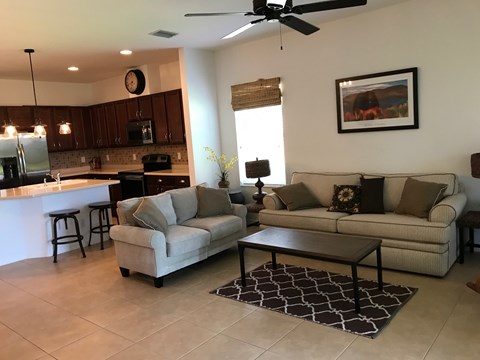 a living room and kitchen with a couch and a table