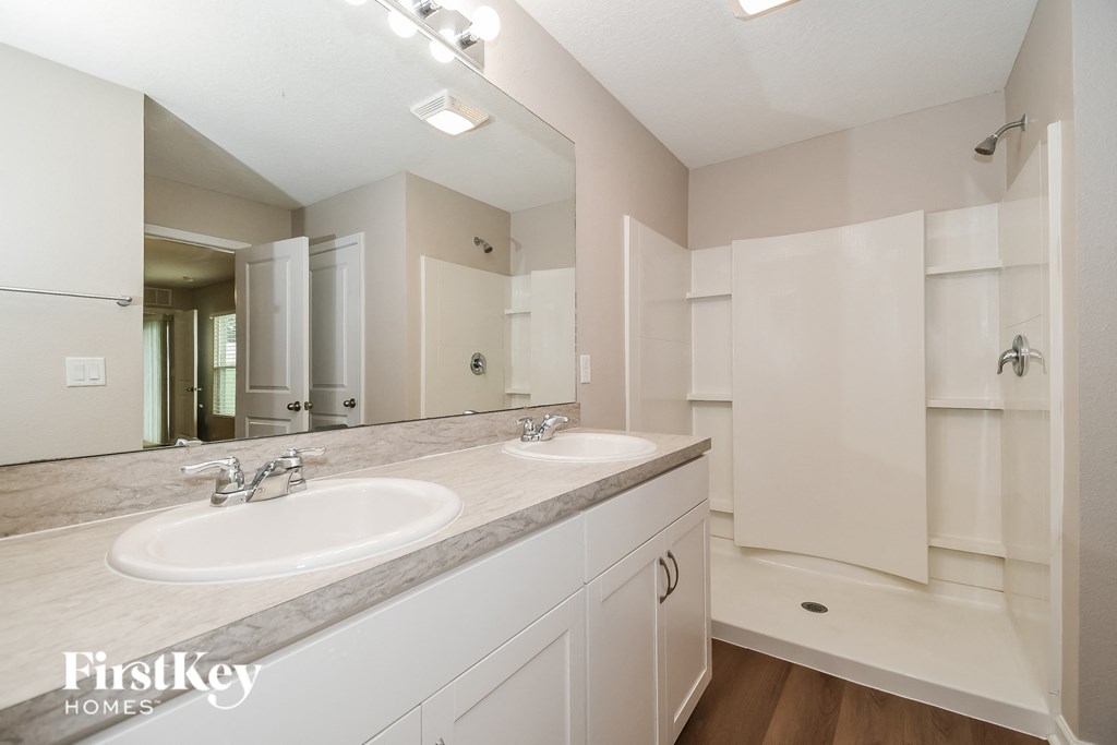 a bathroom with two sinks and a large mirror
