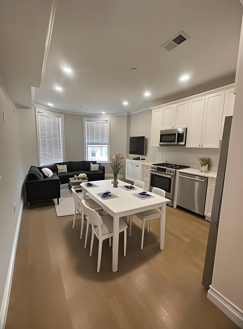 A modern kitchen with a dining table and chairs.