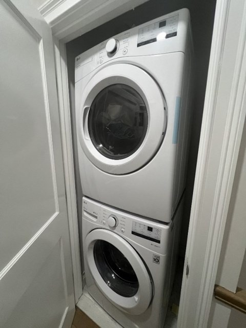 A white washing machine is in a small space.