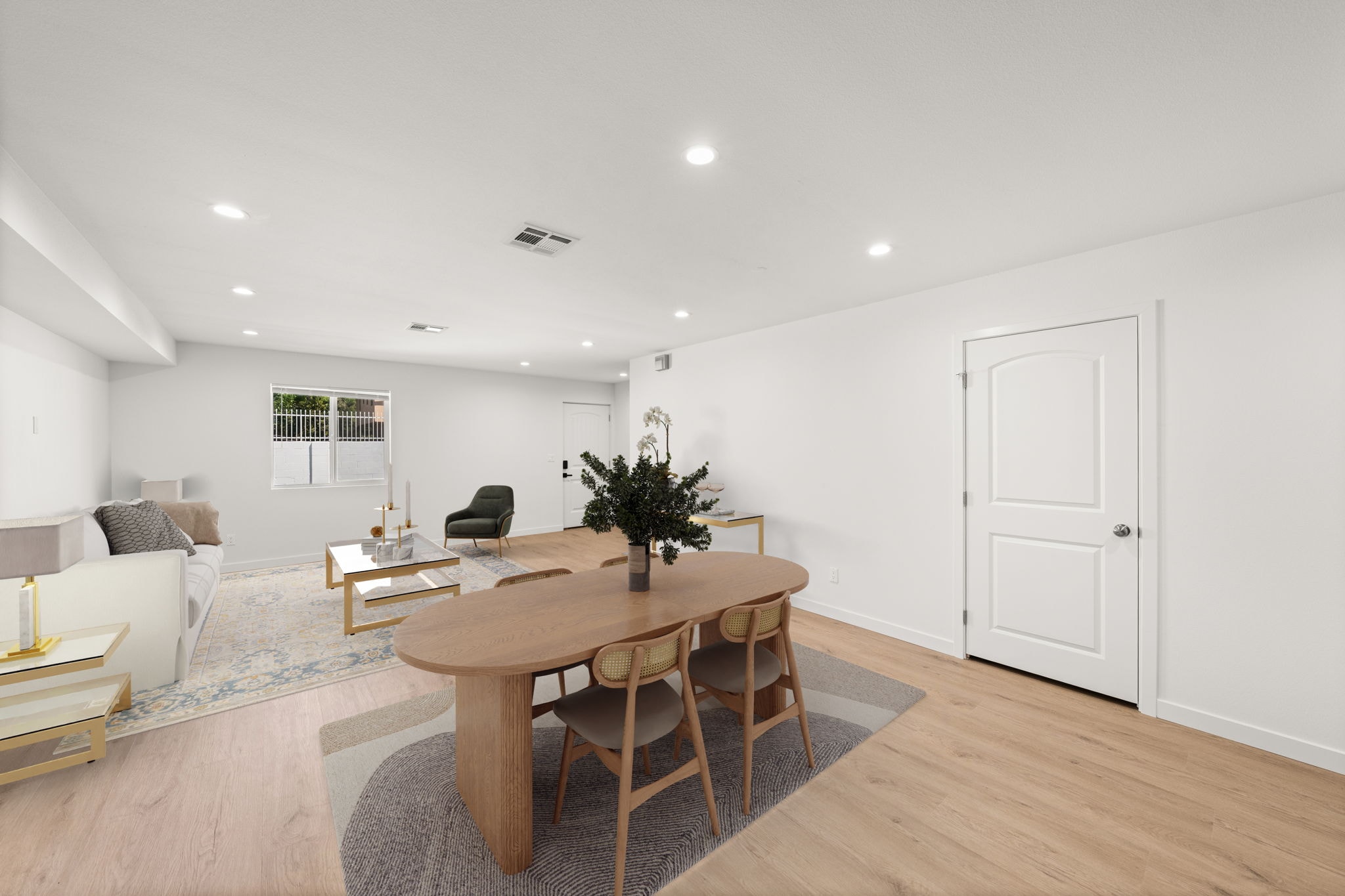 A dining room with a wooden table and chairs.