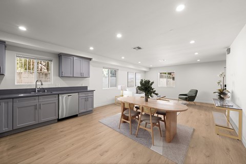 A modern kitchen with a dining table and chairs.