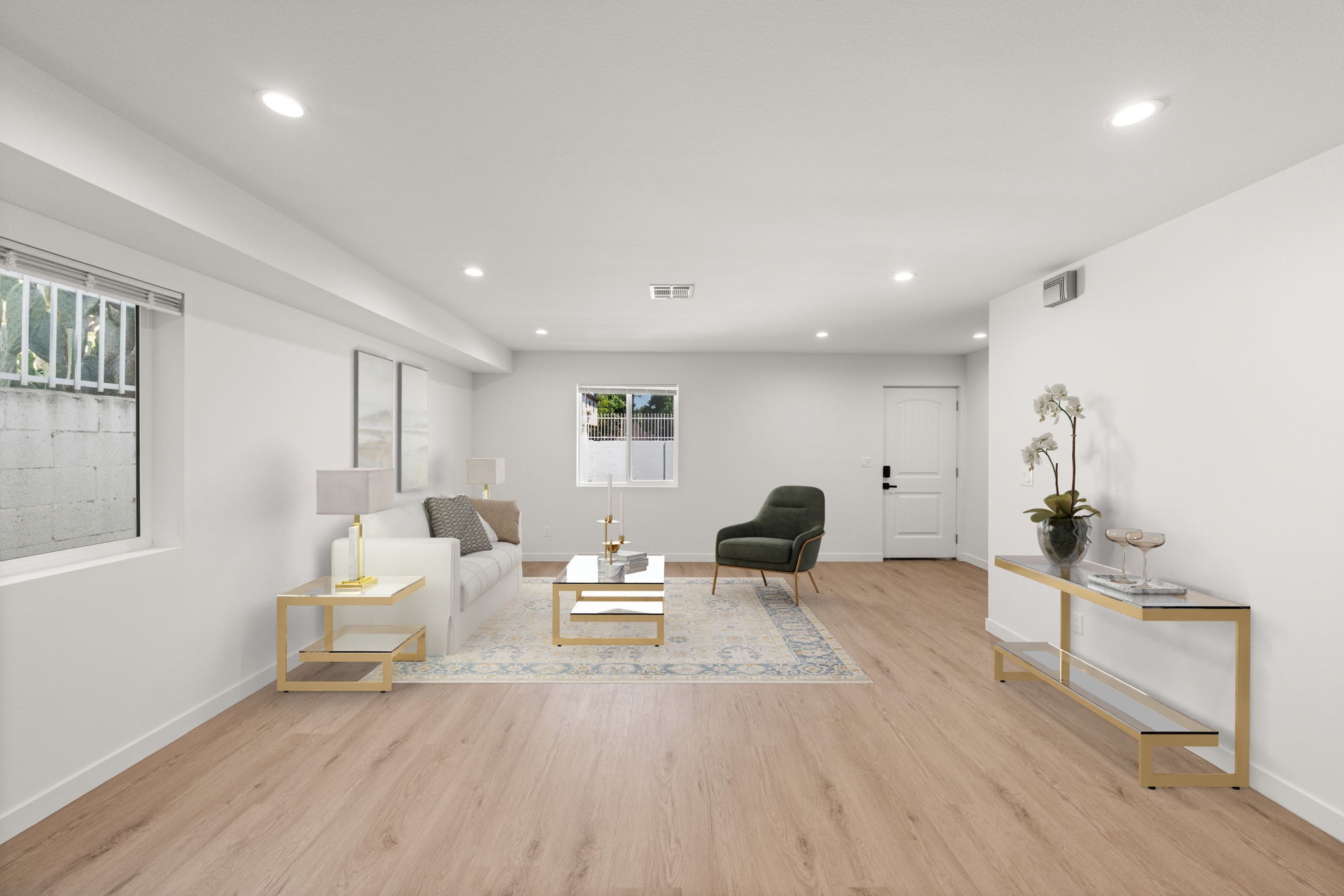 A living room with a black chair and a white sofa.