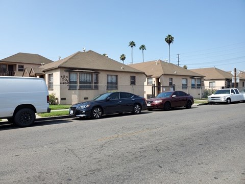 a street with cars parked in front of houses