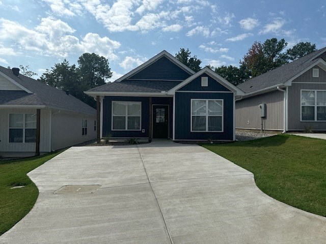 a blue house with a concrete driveway