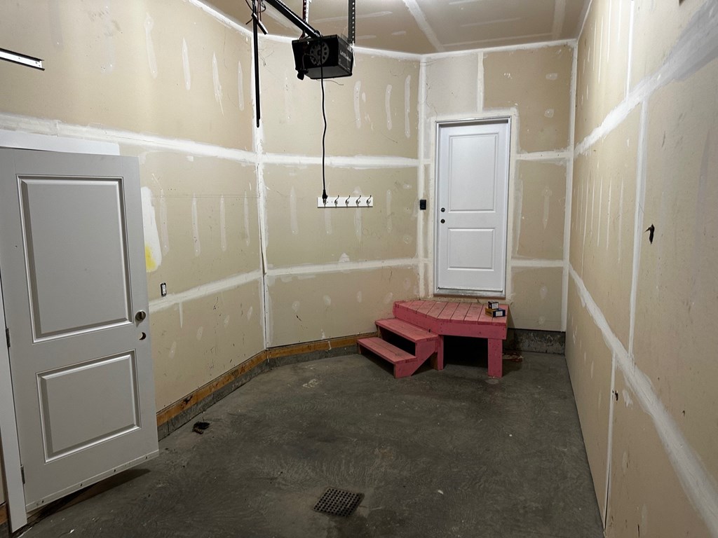 A room with a door and a window under construction.