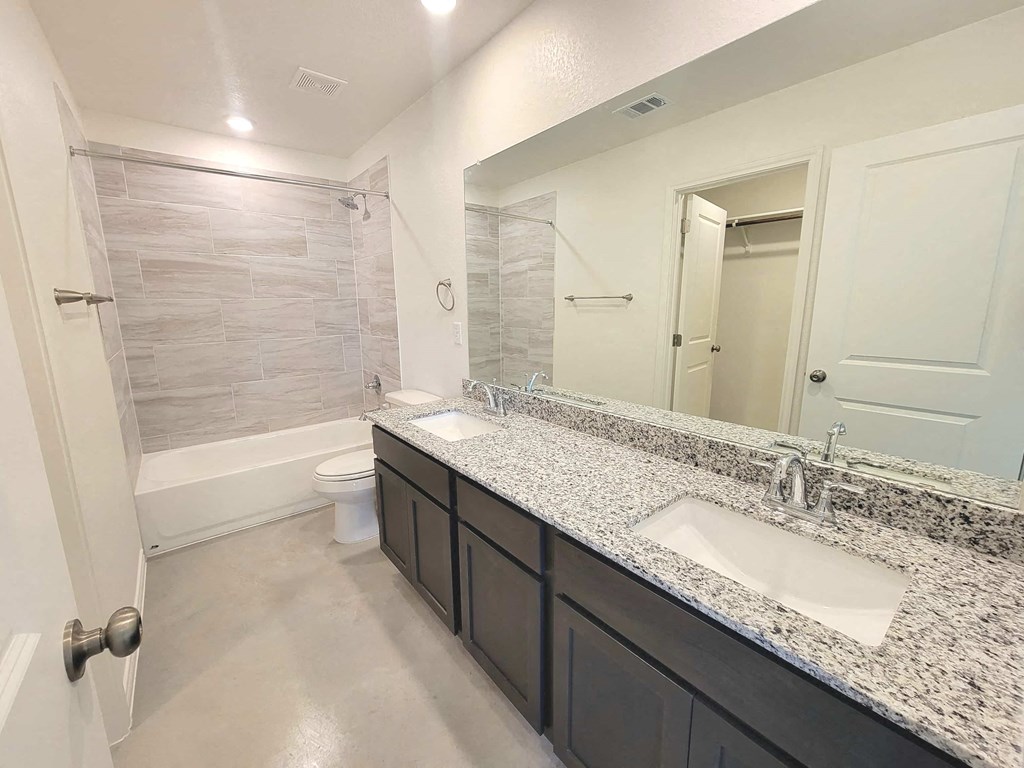 a bathroom with a sink and a toilet and a shower