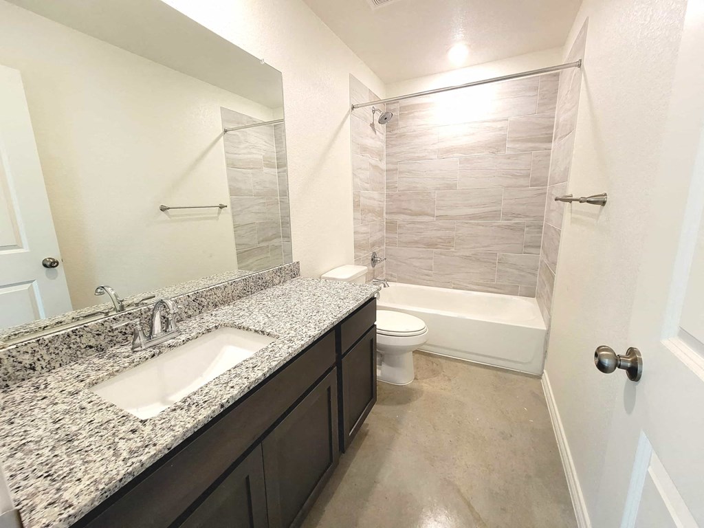 a bathroom with a sink and a toilet and a shower