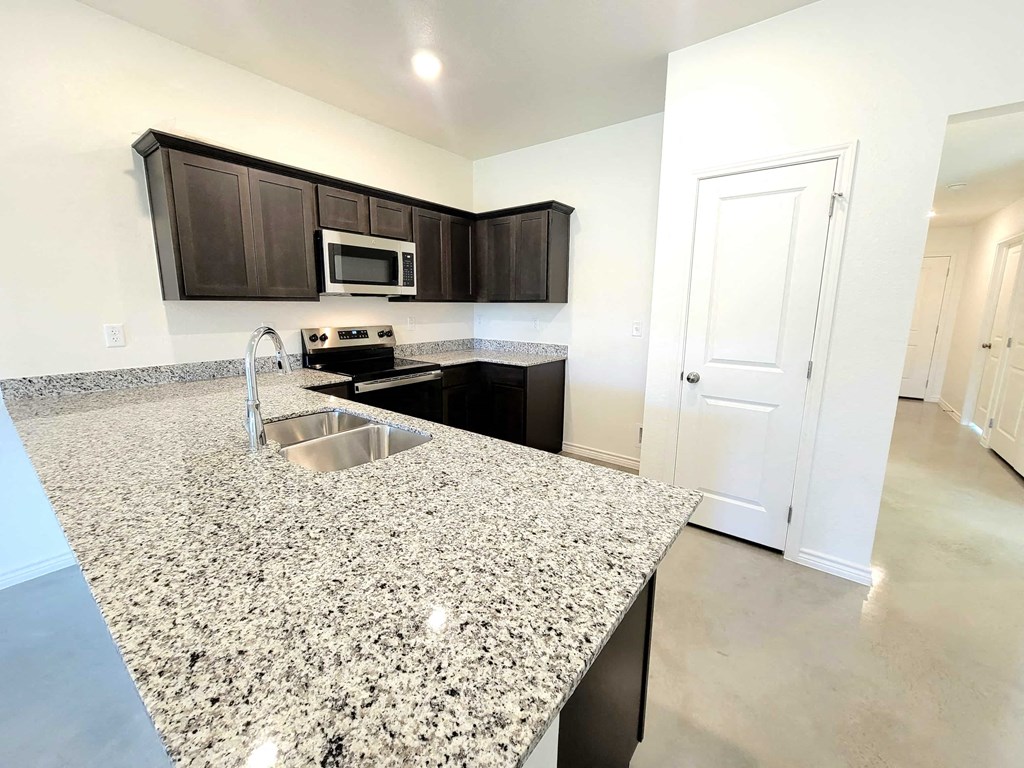 a kitchen with granite counter tops and a sink