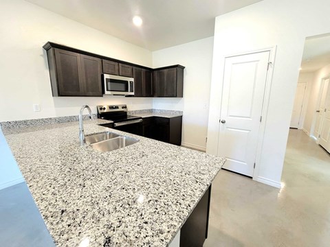 a kitchen with granite counter tops and a sink