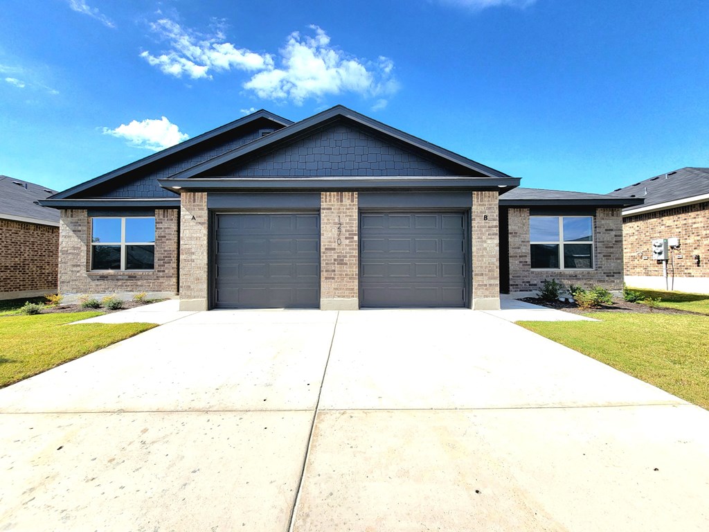 a house with a garage and a driveway in front of it