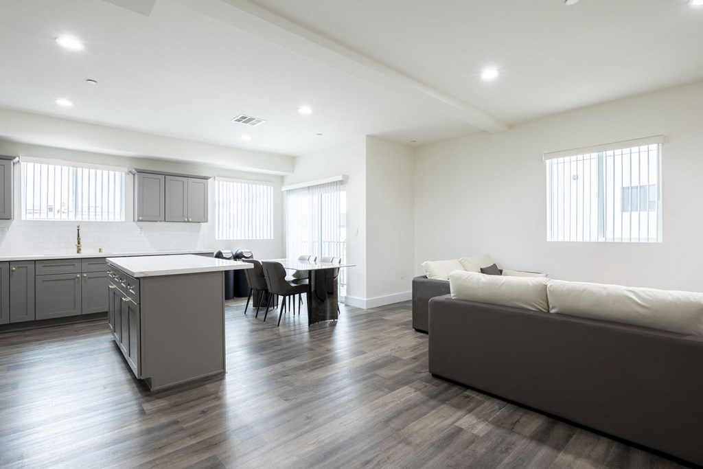 an open living room and kitchen with a couch and a table