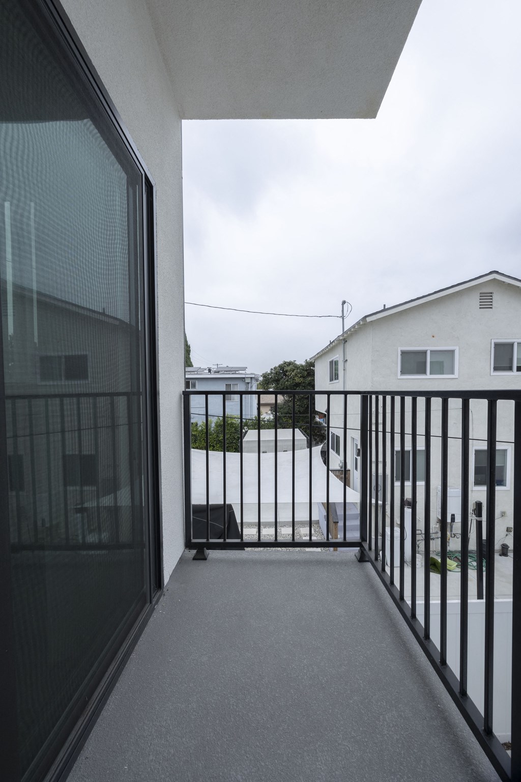 a view of the balcony from the living room of a condo