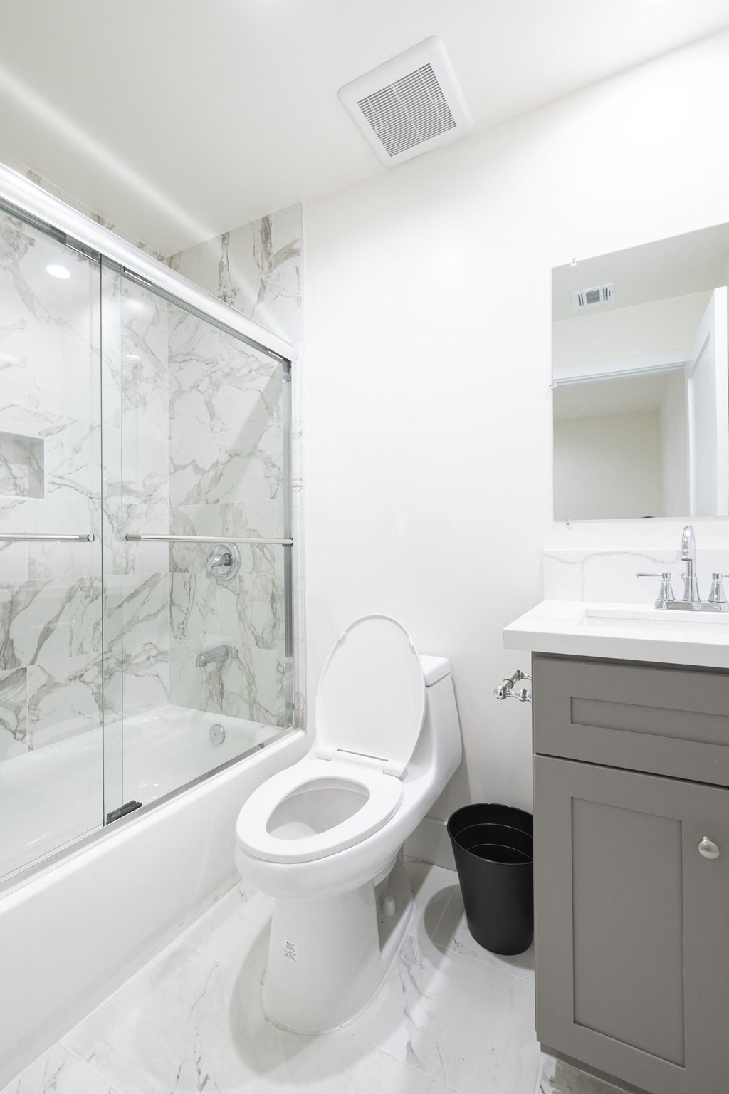 a white bathroom with a shower and a toilet