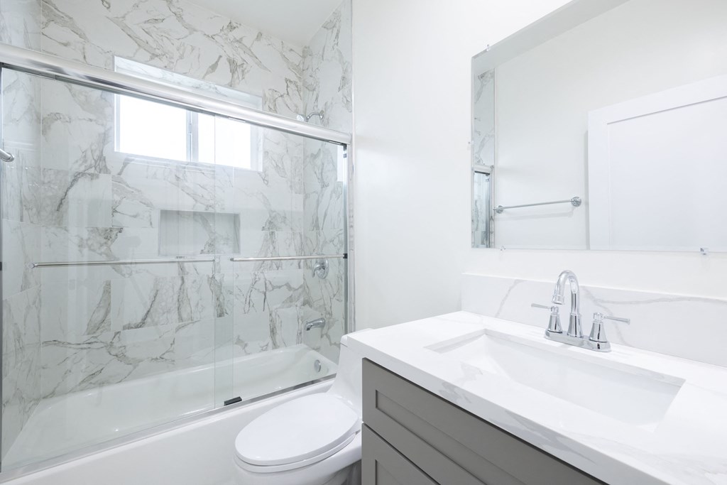 a bathroom with a sink toilet and a shower
