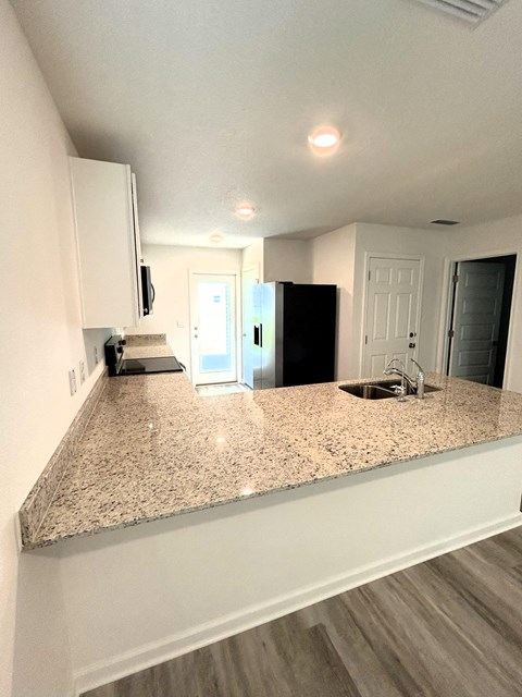 a kitchen with a granite counter top and a sink