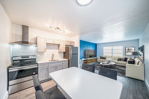 A modern kitchen with a dining table and chairs.