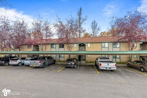 a large building with cars parked in front of it