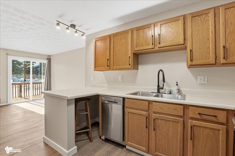 A kitchen with wooden cabinets and a white countertop.