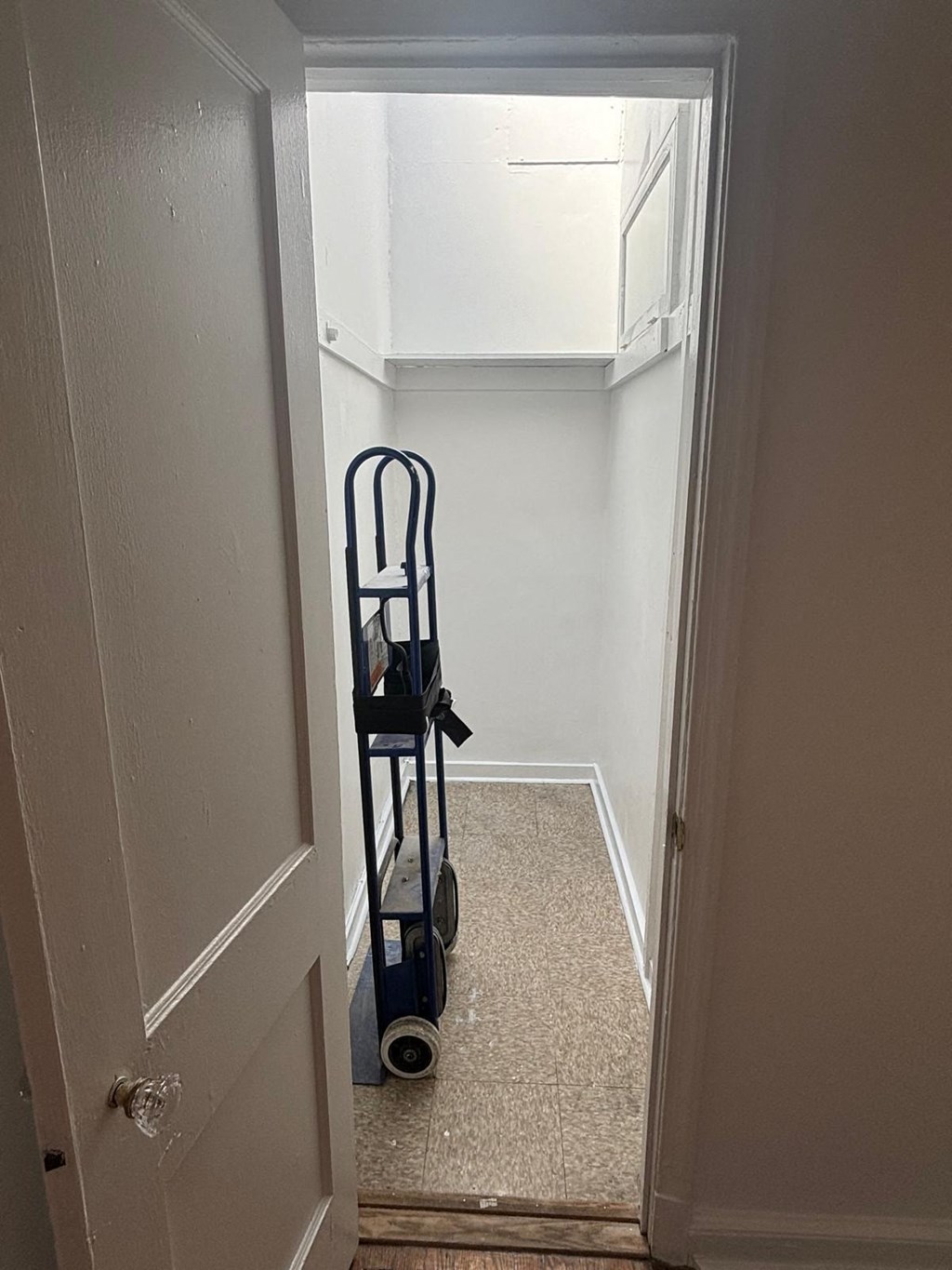 a walk in closet in a home with a wheelchair in it