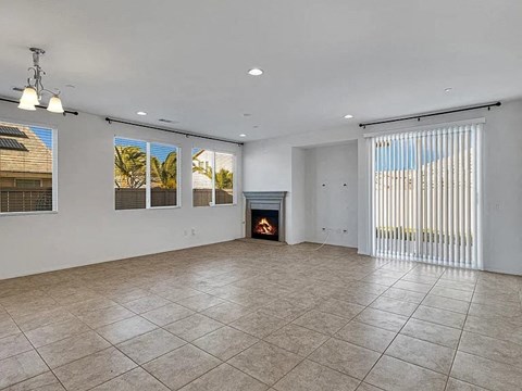 an empty living room with a fireplace
