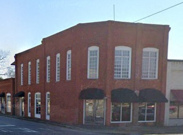 a large brick building on the side of a street