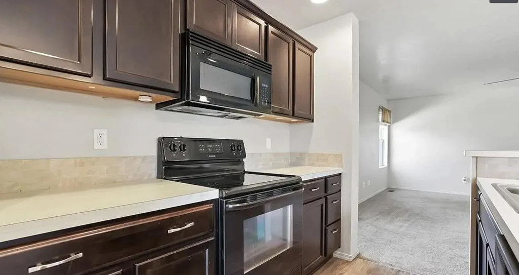 a kitchen with a stove and a microwave
