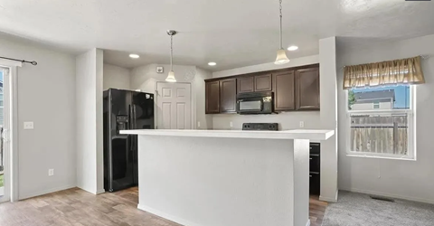 a kitchen with a counter top and a refrigerator