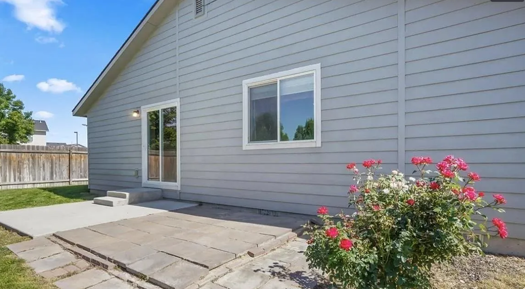a white house with a patio in front of it
