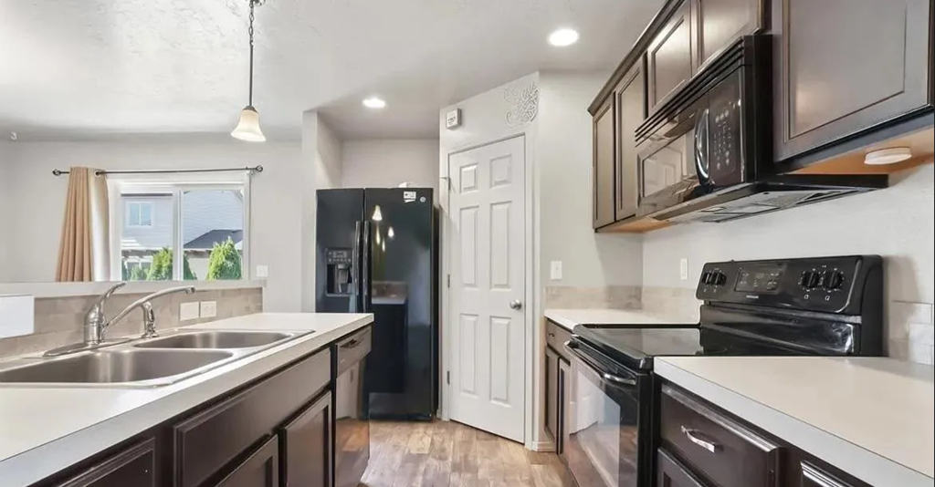 an empty kitchen with a stove and a sink