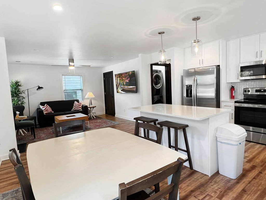 an open kitchen and living room with a dining room table