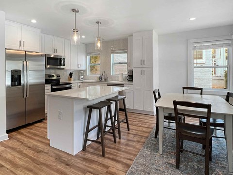 a kitchen with an island and a table with chairs