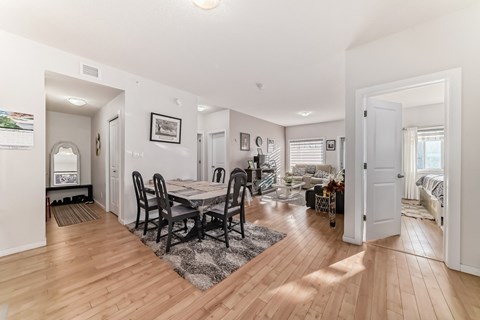 a living room and dining room with a table and chairs