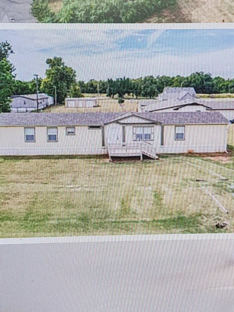 an aerial view of an old trailer house in a field