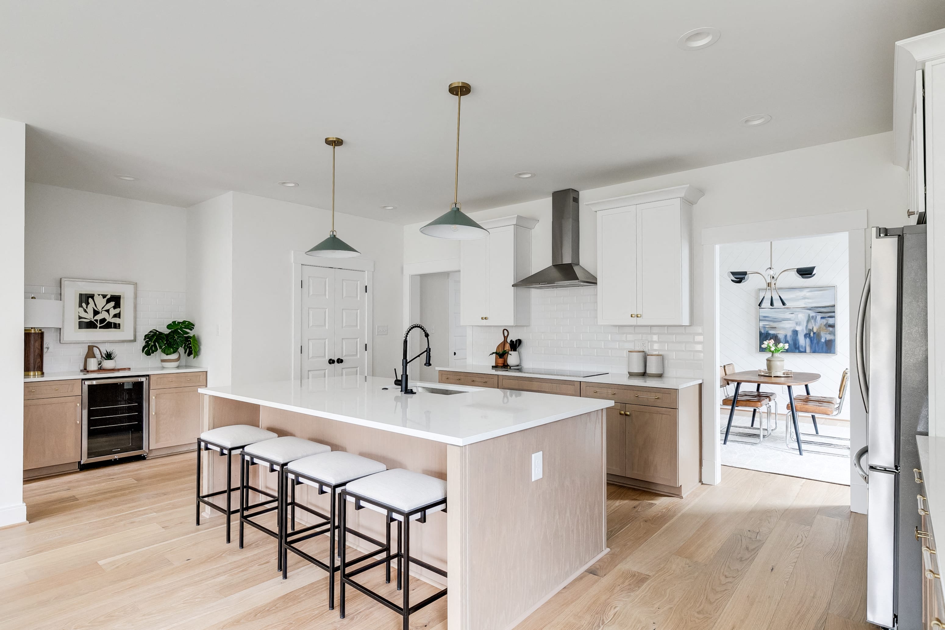 a large kitchen with an island and stools
